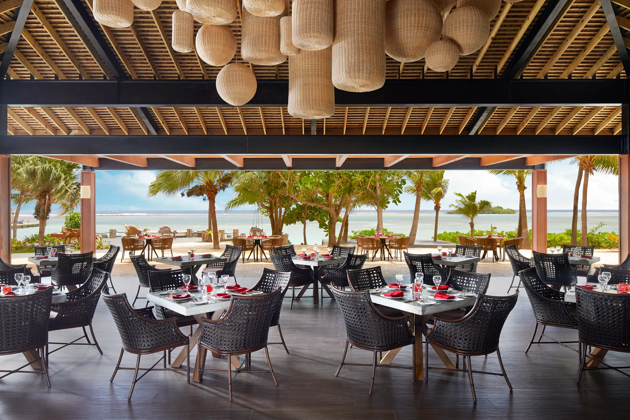 Coyaba Restaurant at Zoëtry Montego Bay Jamaica featuring open-air oceanfront dining, palm tree views, and elegant international fusion cuisine setting.