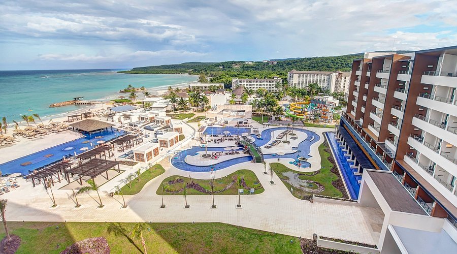 Royalton Blue Waters Montego Bay modern all-inclusive resort with overwater bungalows, multiple pools, and family-friendly amenities.