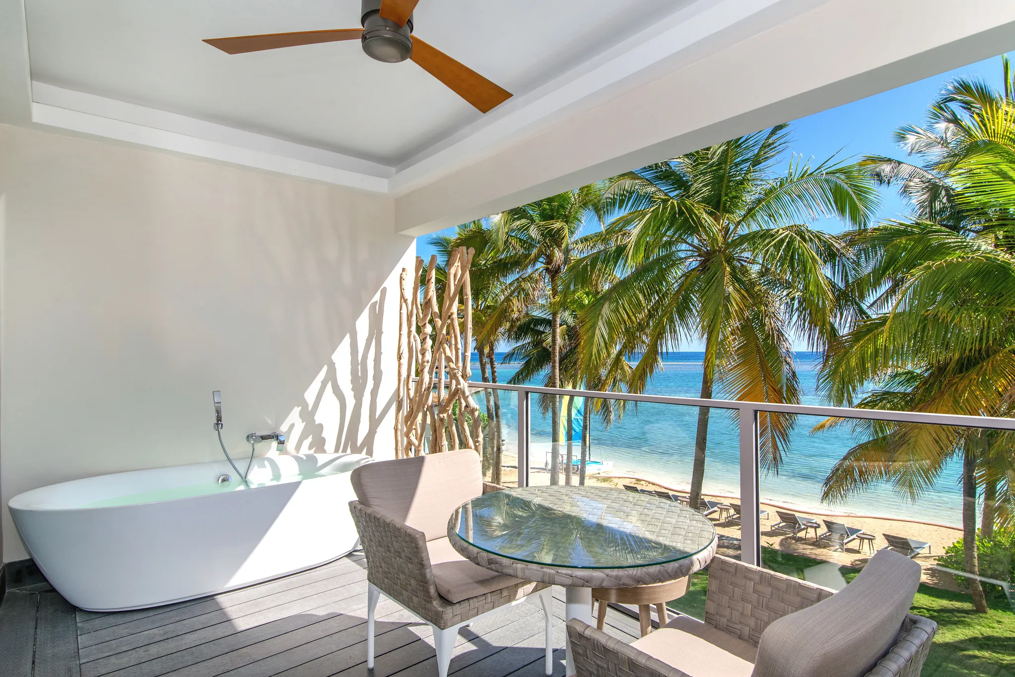 Junior Suite Ocean View balcony with soaking tub and Caribbean Sea views at Zoëtry Montego Bay Jamaica.