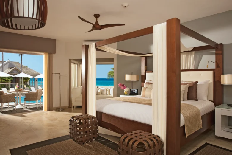 Junior Suite Ocean View with king canopy bed and oceanfront balcony at Zoëtry Montego Bay Jamaica.