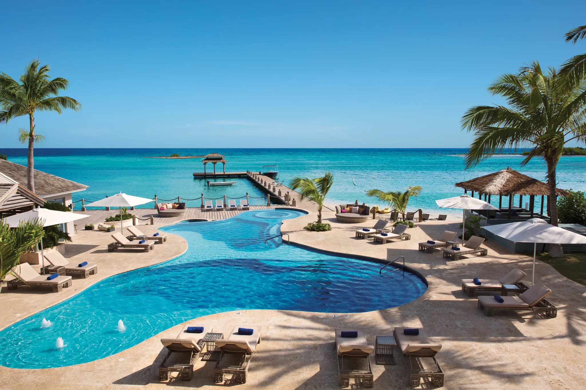 Daytime view of the infinity-style pool overlooking the Caribbean Sea at Zoëtry Montego Bay Jamaica.