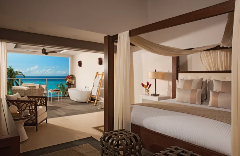 Master Suite Ocean View king bed with canopy and ocean view terrace at Zoëtry Montego Bay Jamaica.