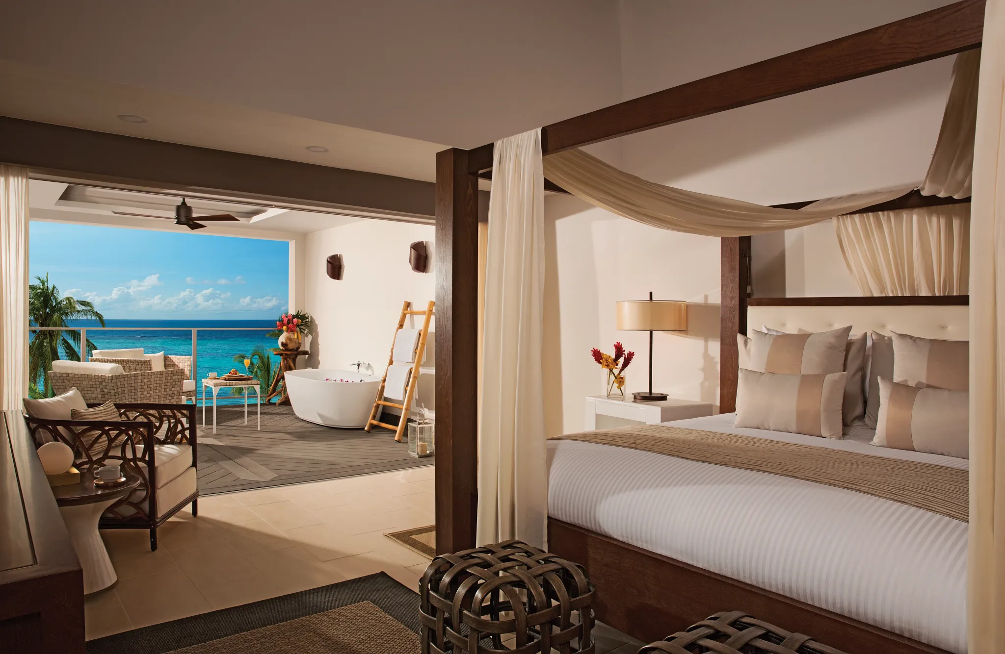 Master Suite Ocean View king bed with canopy and ocean view terrace at Zoëtry Montego Bay Jamaica.
